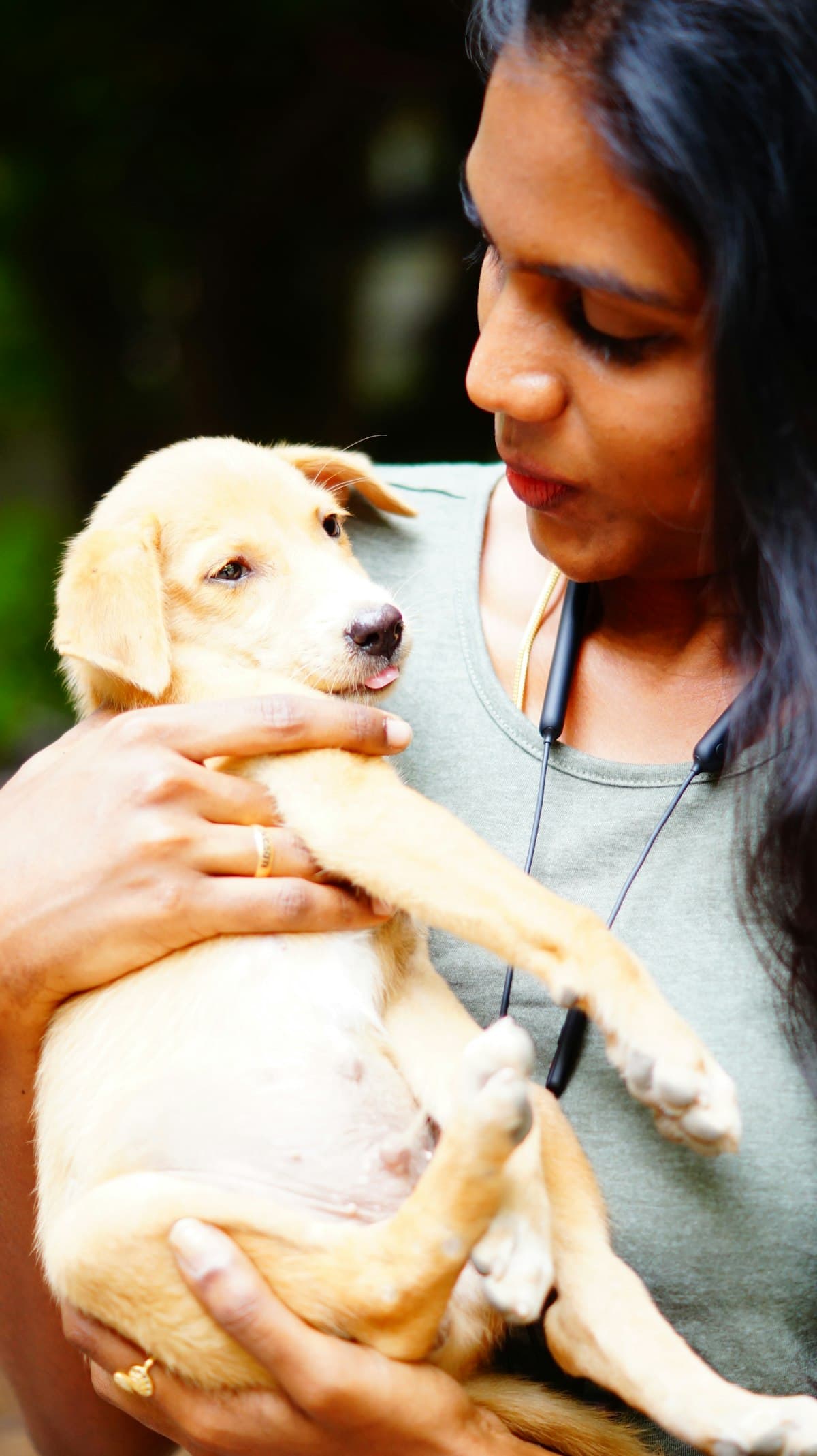 A pet parent holding her puppy